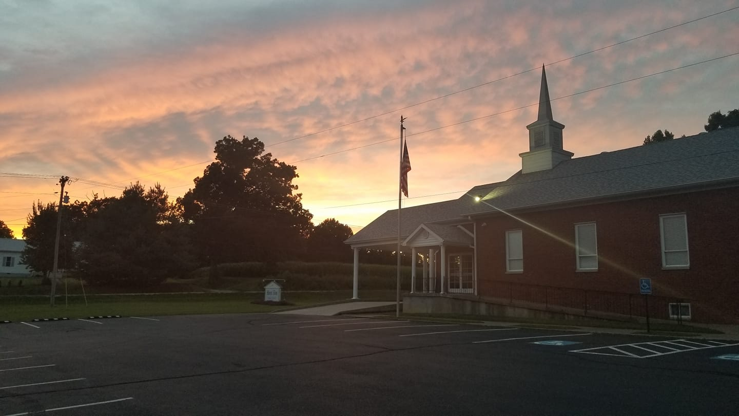 Shot of the side of a Church from the parking lot at sunset.