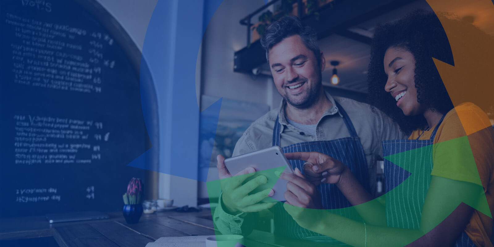 Two co-workers stand at a front counter smiling and using a tablet to work. Conexon icon overtop.